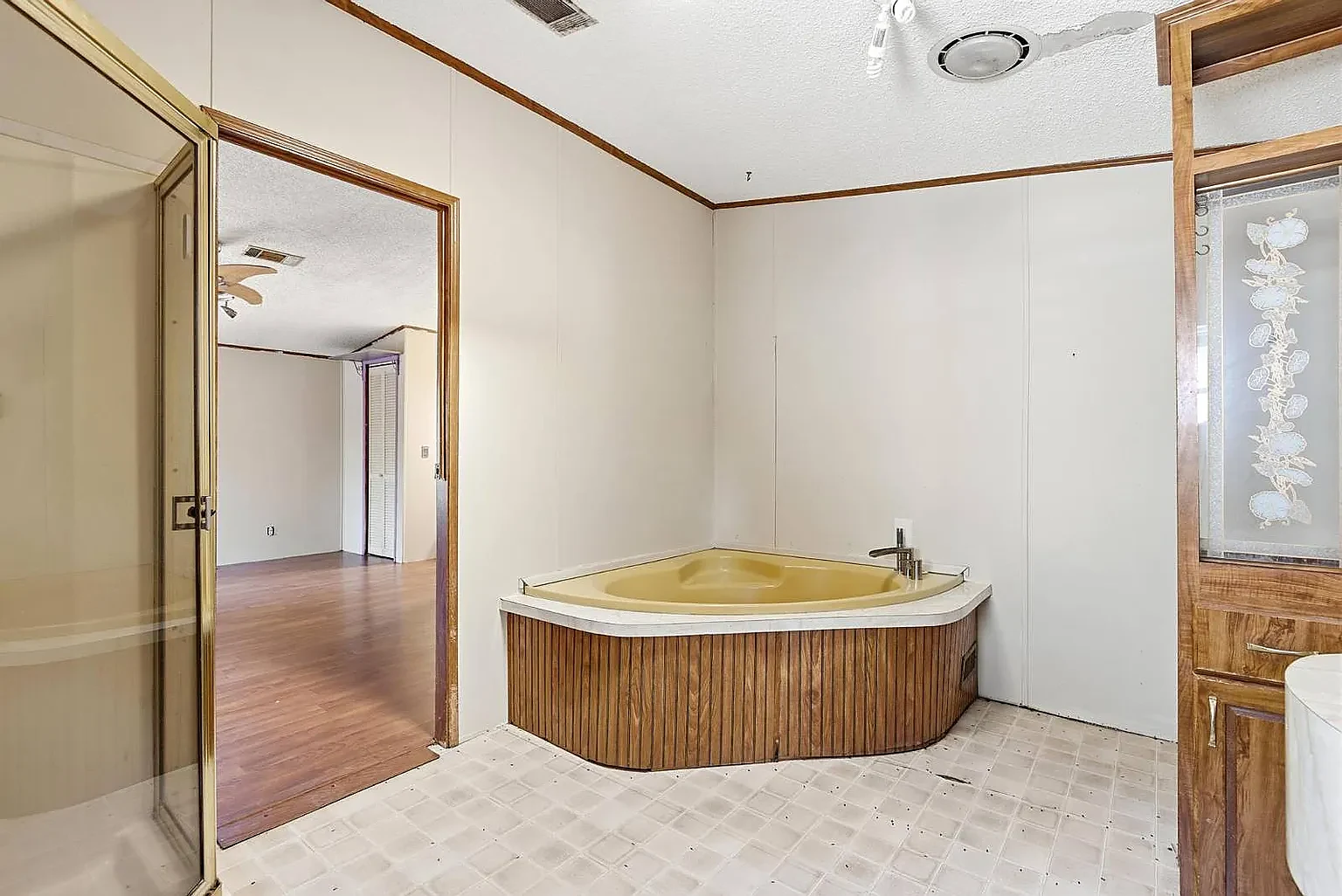 Primary bath — corner garden tub and glass shower