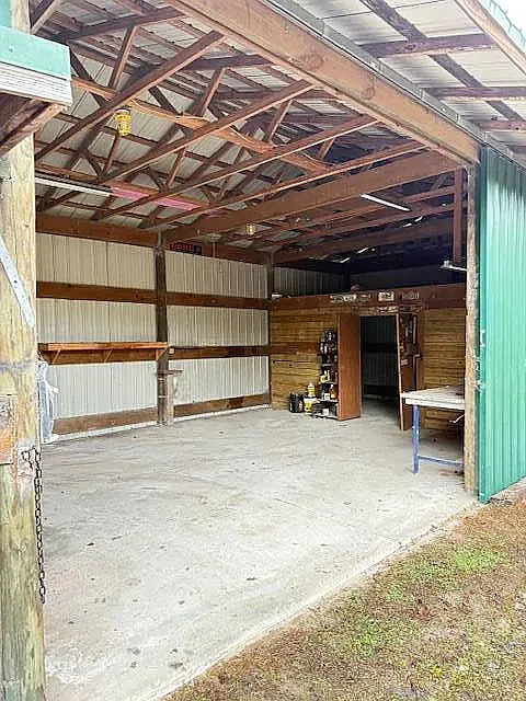 Inside the hangar — concrete slab, high ceilings, roll-up door